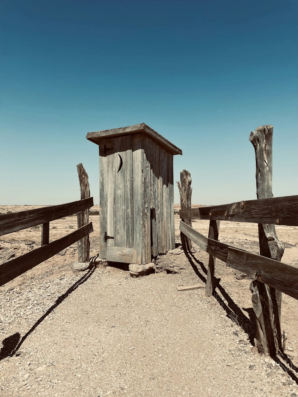 brown wooden lifeguard house on brown sand during daytime