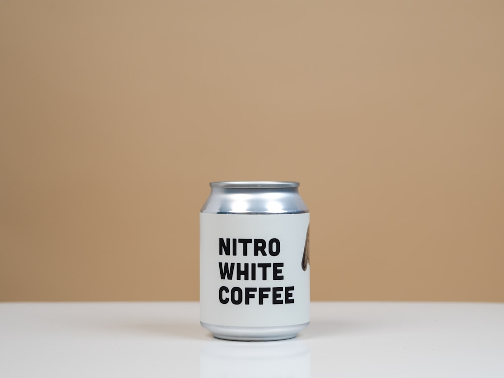 a can of nitro white coffee sitting on a table