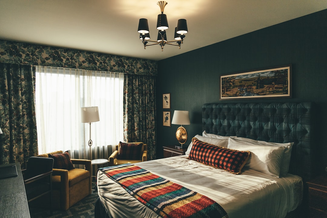 black and white uplight chandelier turned on near brown sofa, Graduate Hotels.<p></figure>Instagram//@outdoorpixs