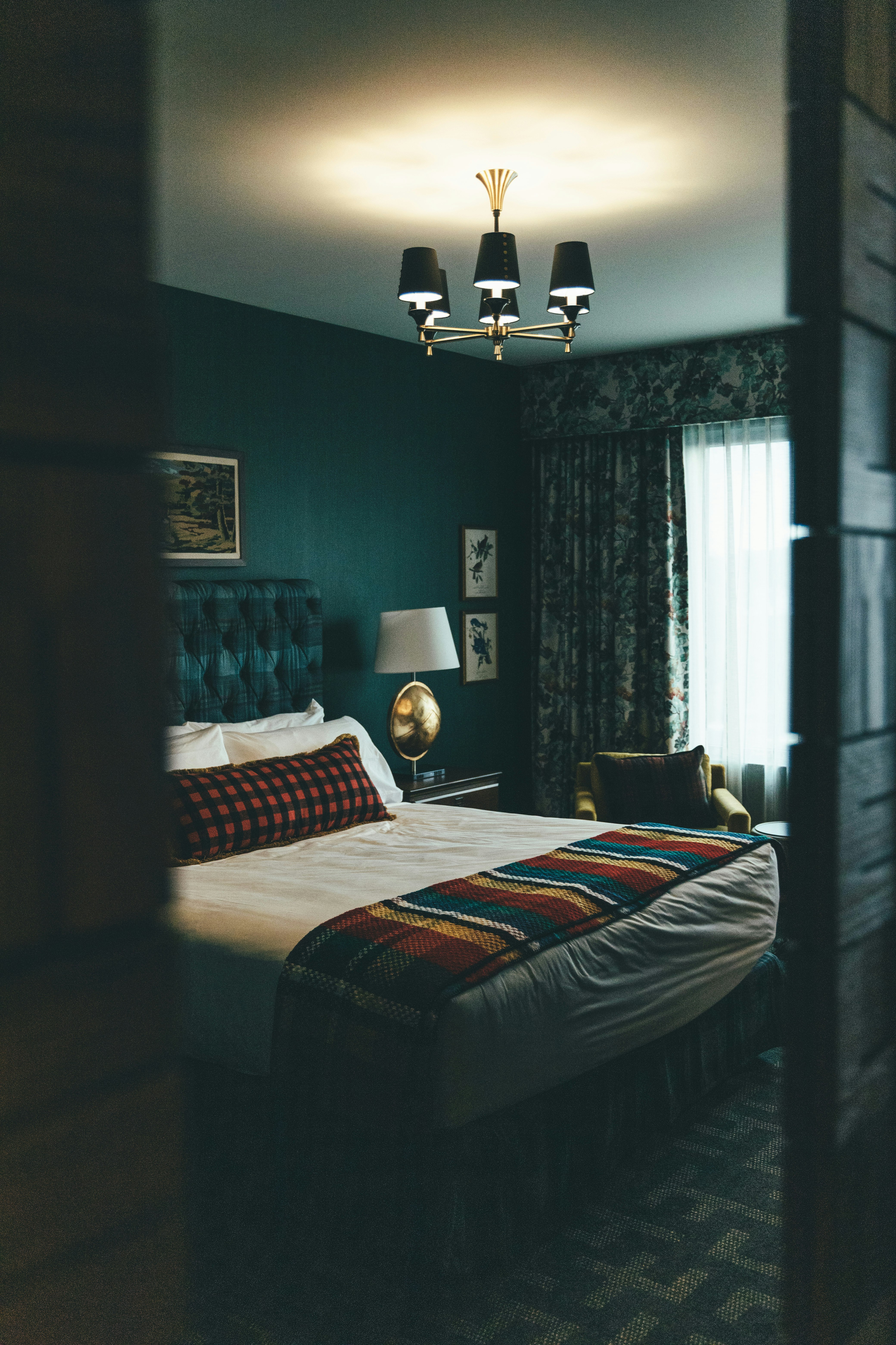 black and white floor lamp near bed