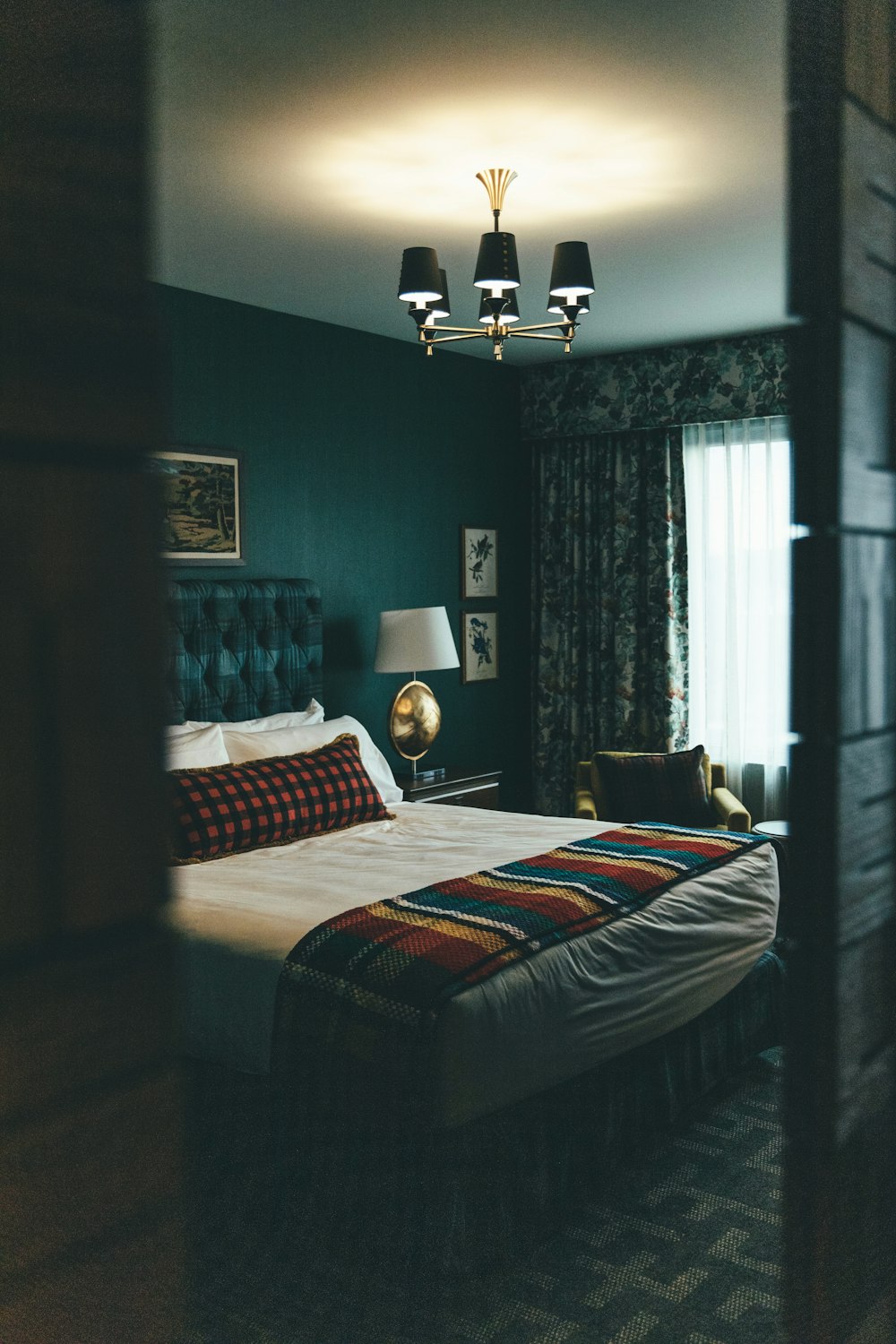 black and white floor lamp near bed