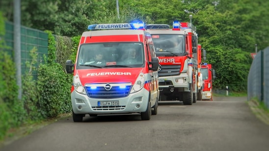Firefighters from Bachern station responding together during a local emergency at dusk.