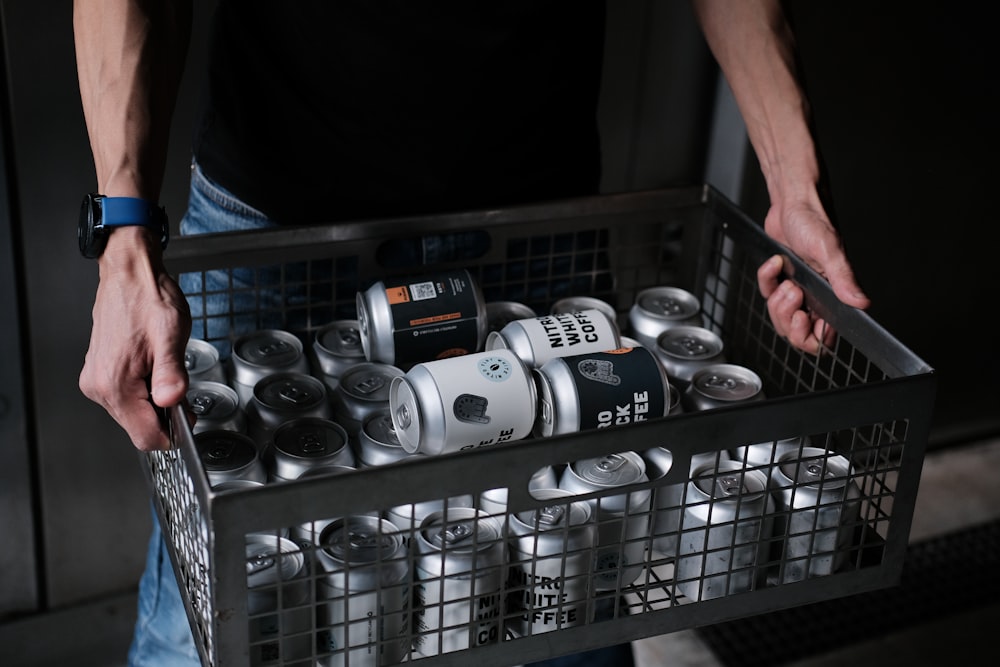 white and black ceramic mugs on stainless steel rack