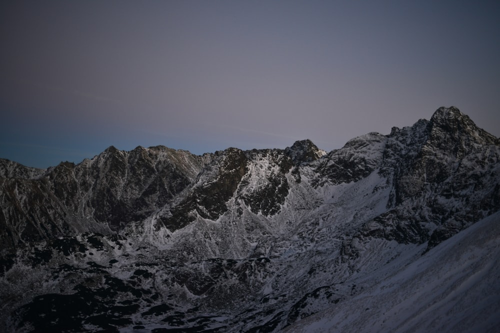 snow covered mountain under blue sky during daytime