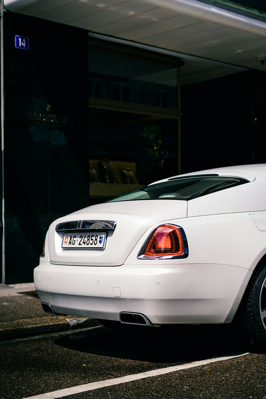 white car parked near building during night time