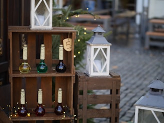 A rustic wooden crate filled with bottles of artisanal Portuguese wine and jars of golden extra virgin olive oil, set against a sunlit vineyard backdrop.