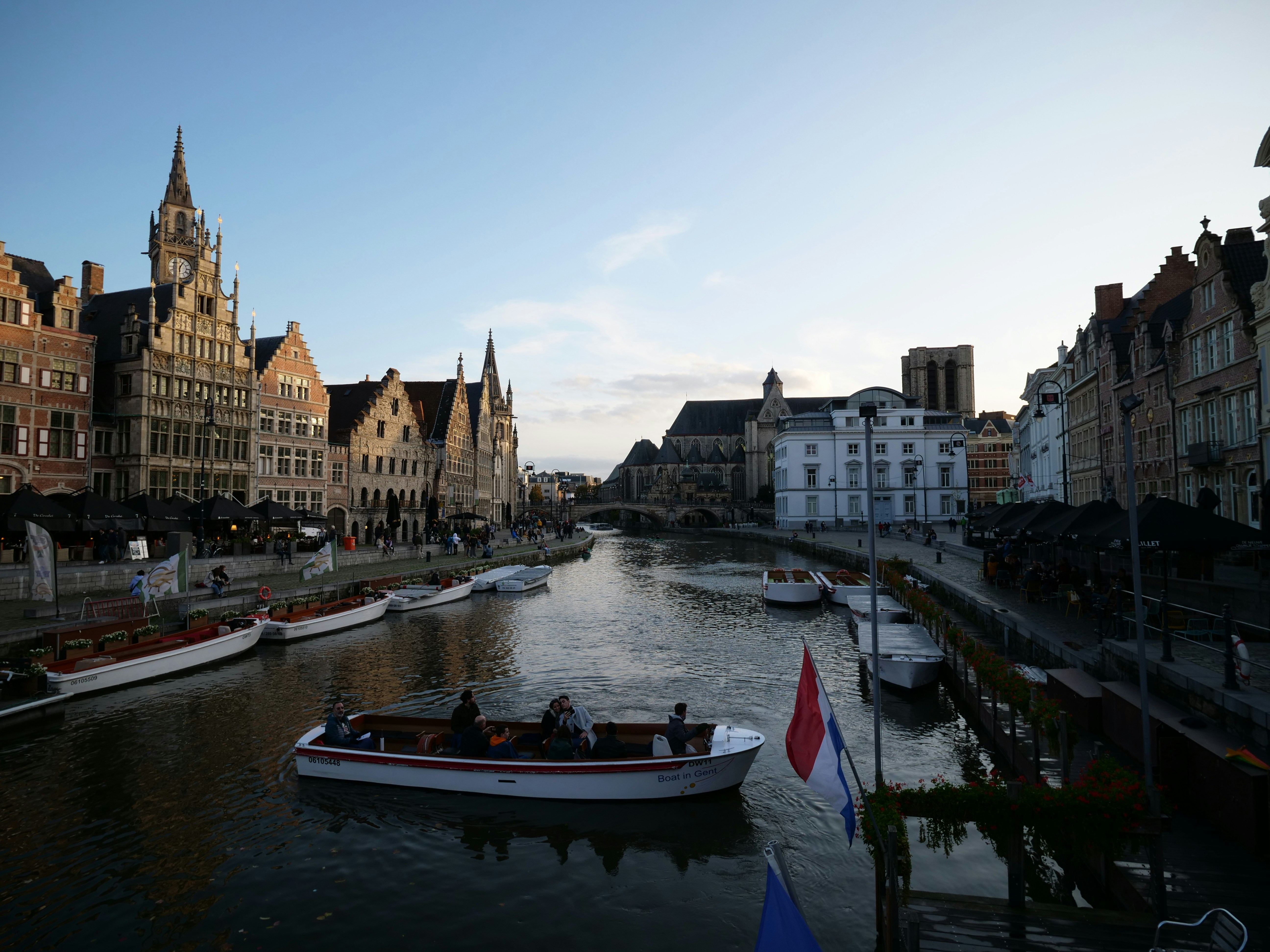 blue and white boat on river near buildings during daytime