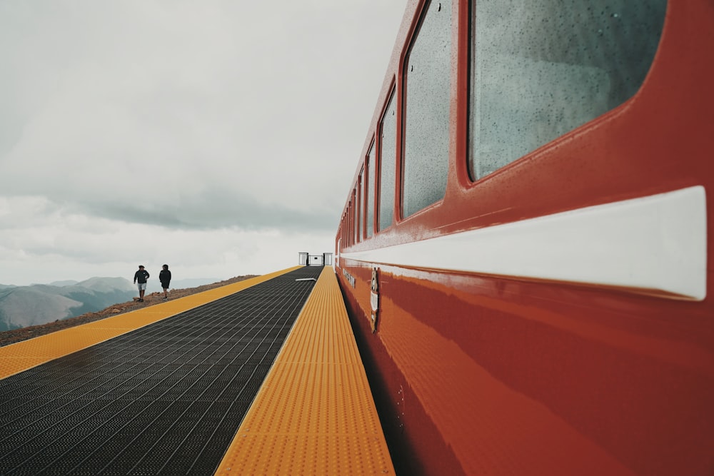 people walking on black and red stairs during daytime