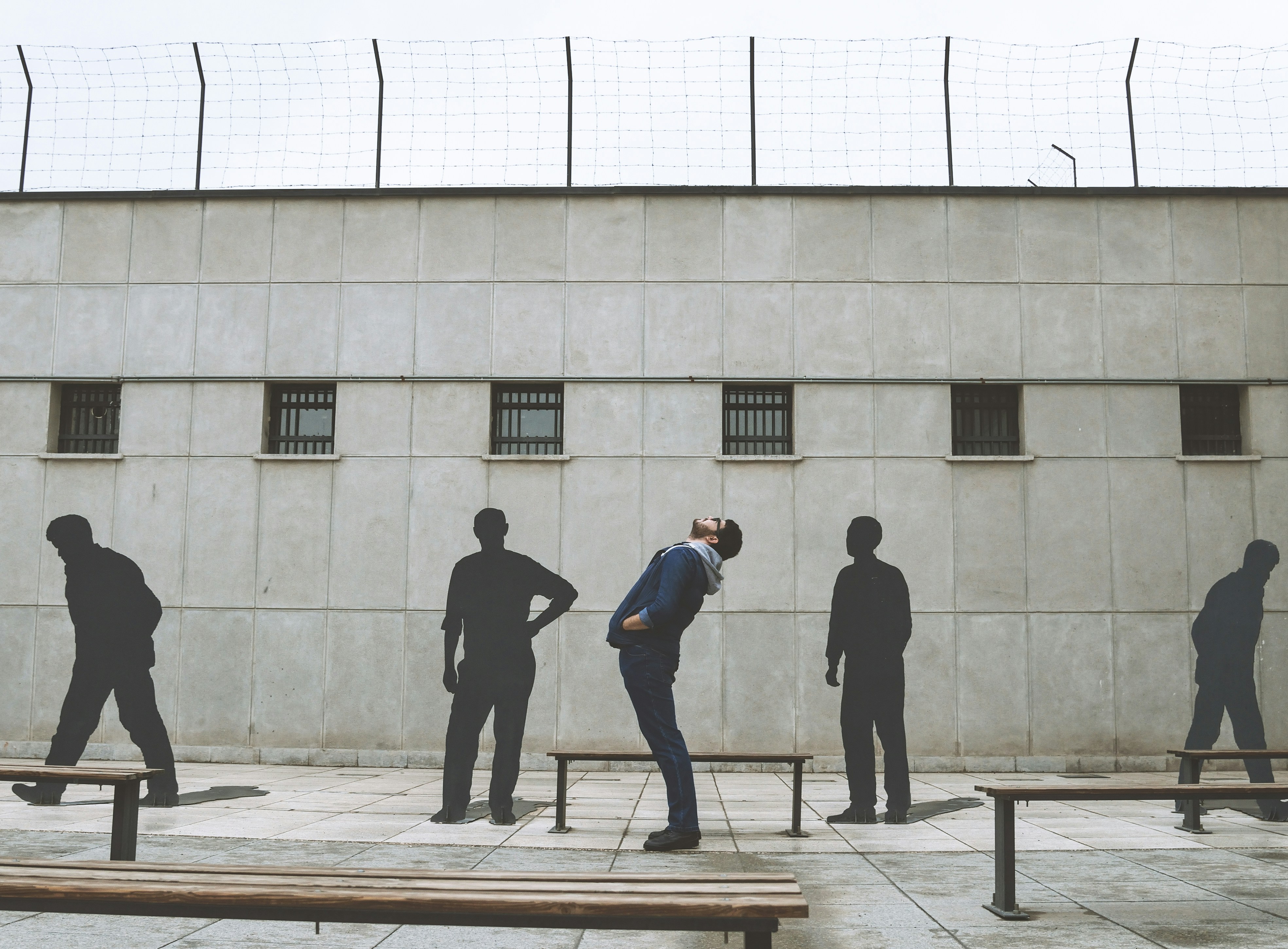 2 men walking on sidewalk near building during daytime