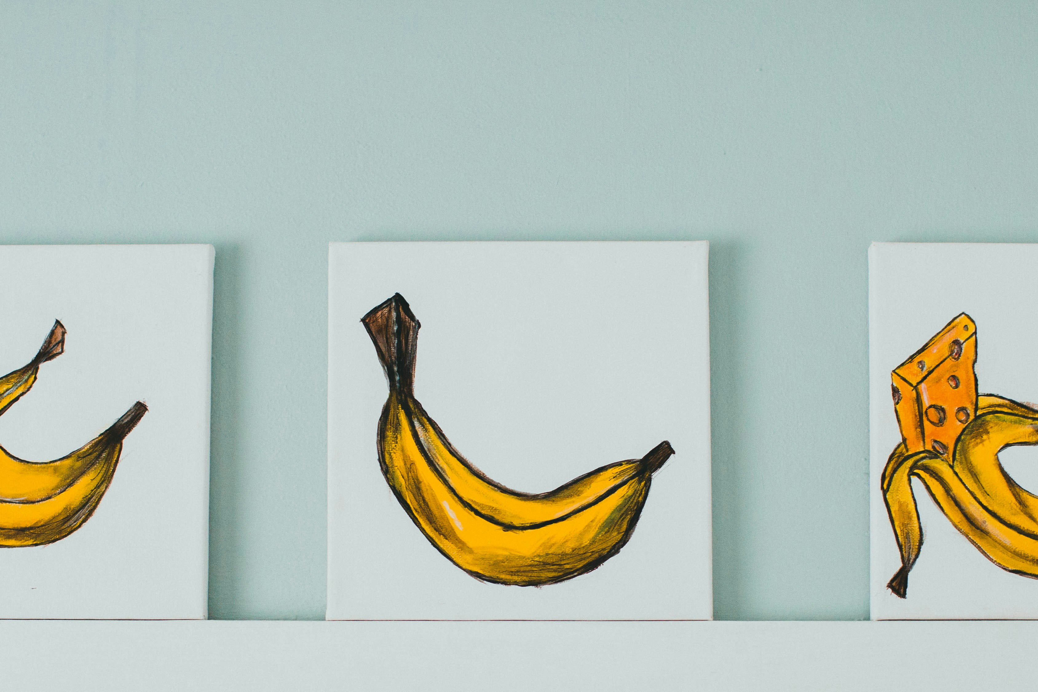 yellow banana fruit on white wall