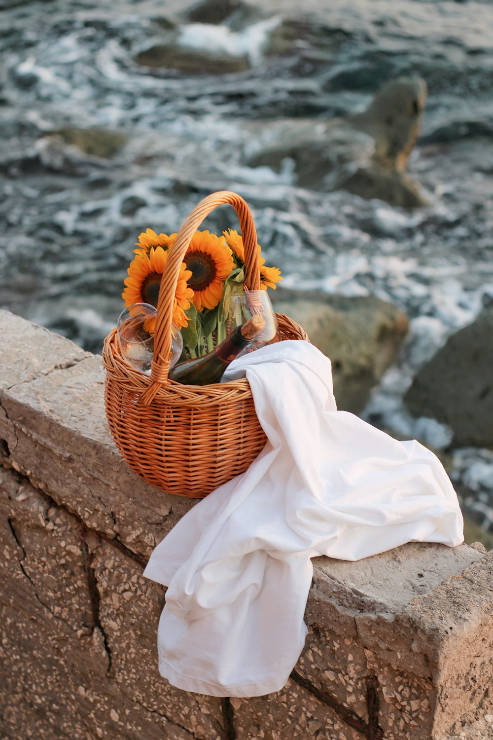 woman in white dress sitting on brown woven basket