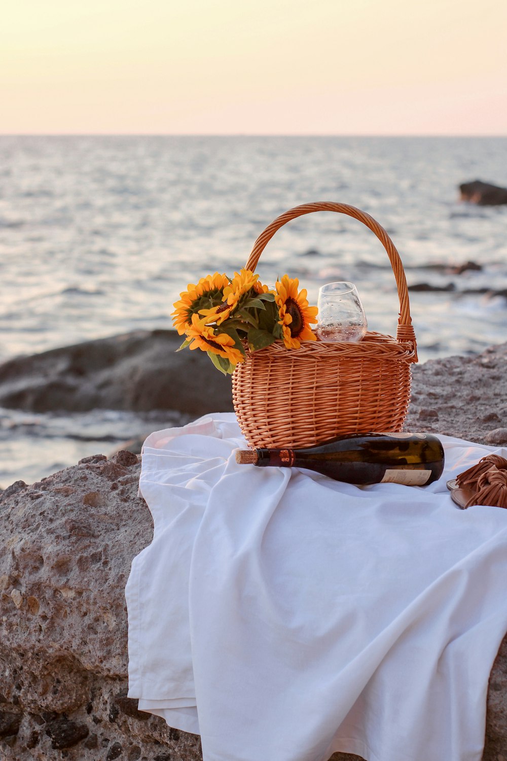 brown woven basket on white textile