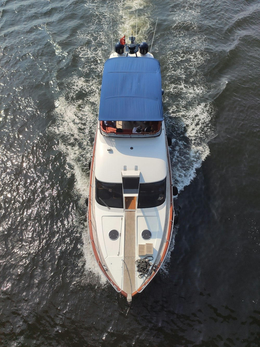 white and blue boat on water during daytime