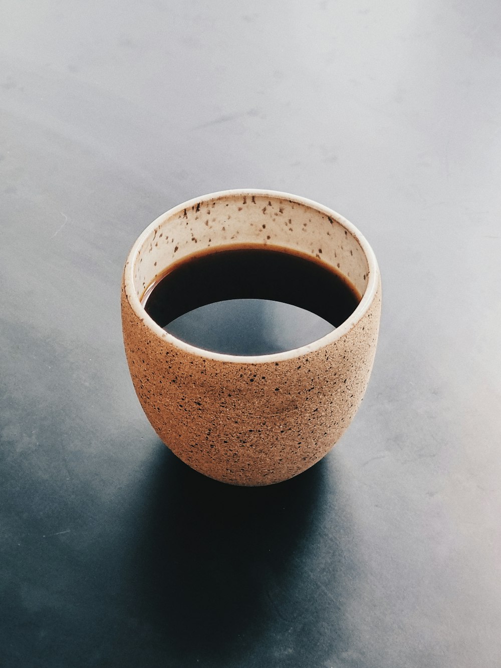 brown ceramic mug on white table