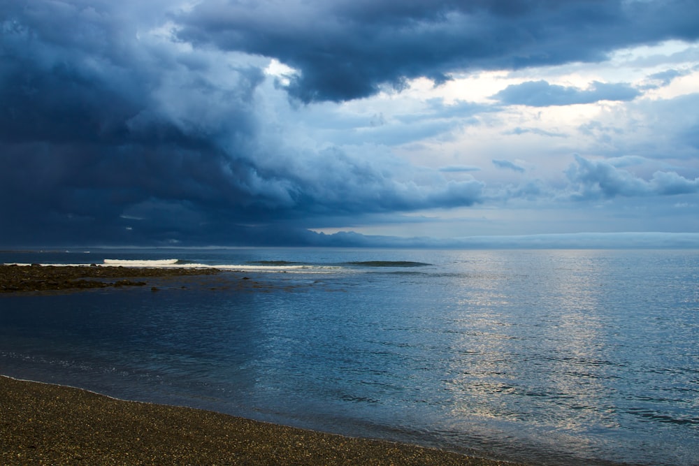 blue sea under white clouds and blue sky during daytime