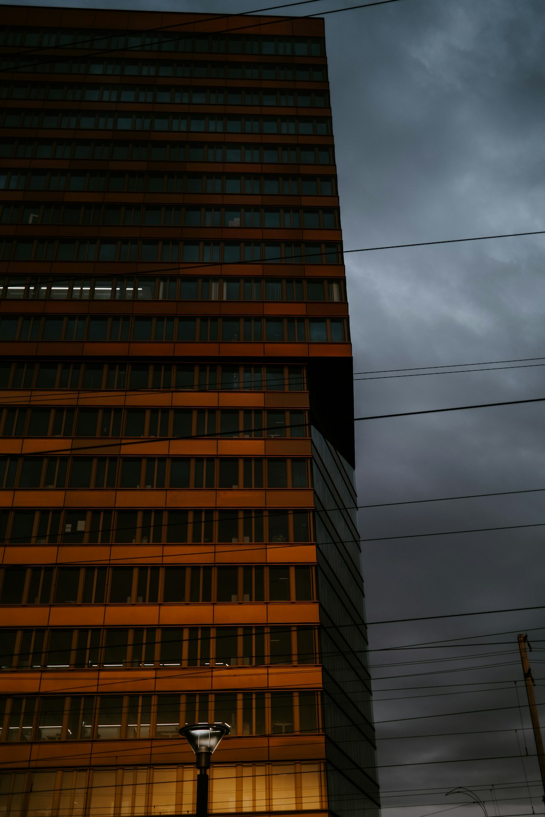 brown concrete building under gray clouds