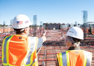 man in white hard hat standing on brown wooden dock during daytime