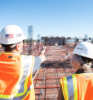 man in white hard hat standing on brown wooden dock during daytime