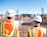 man in white hard hat standing on brown wooden dock during daytime