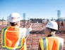 man in white hard hat standing on brown wooden dock during daytime