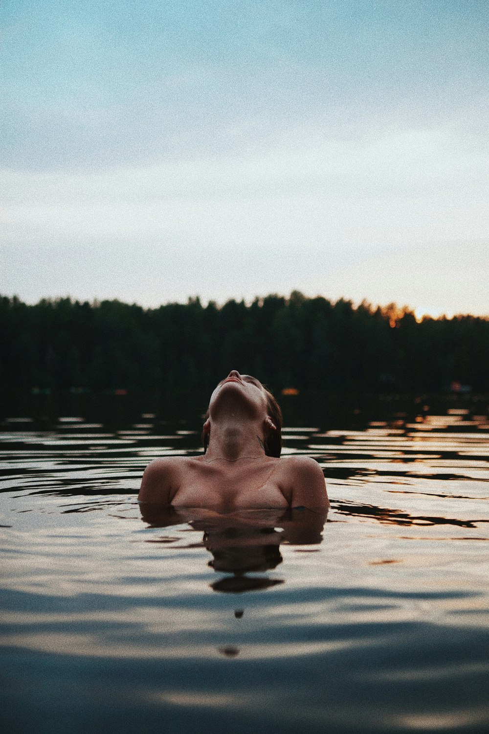topless woman in water during daytime