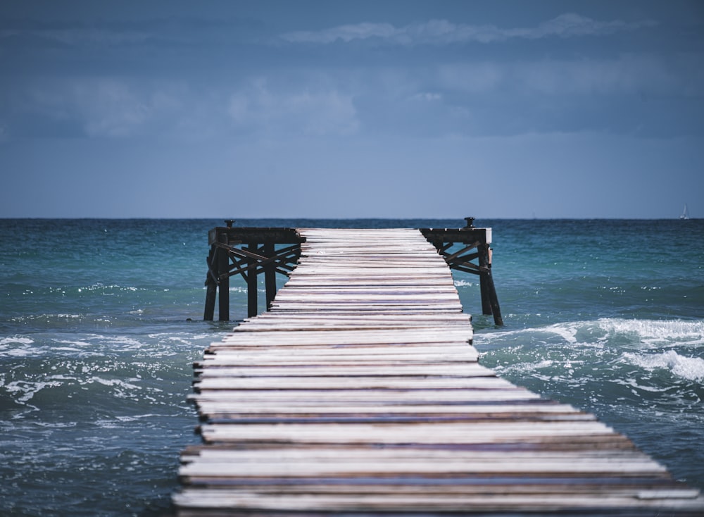 brown wooden dock on sea during daytime