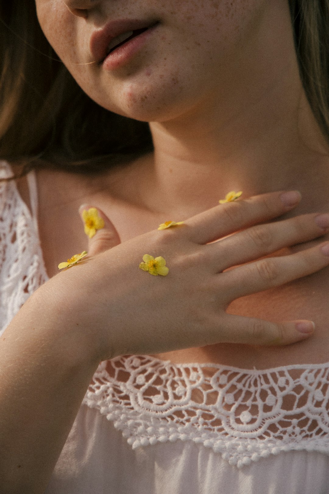 woman in white and brown floral shirt with yellow butterfly on her hand