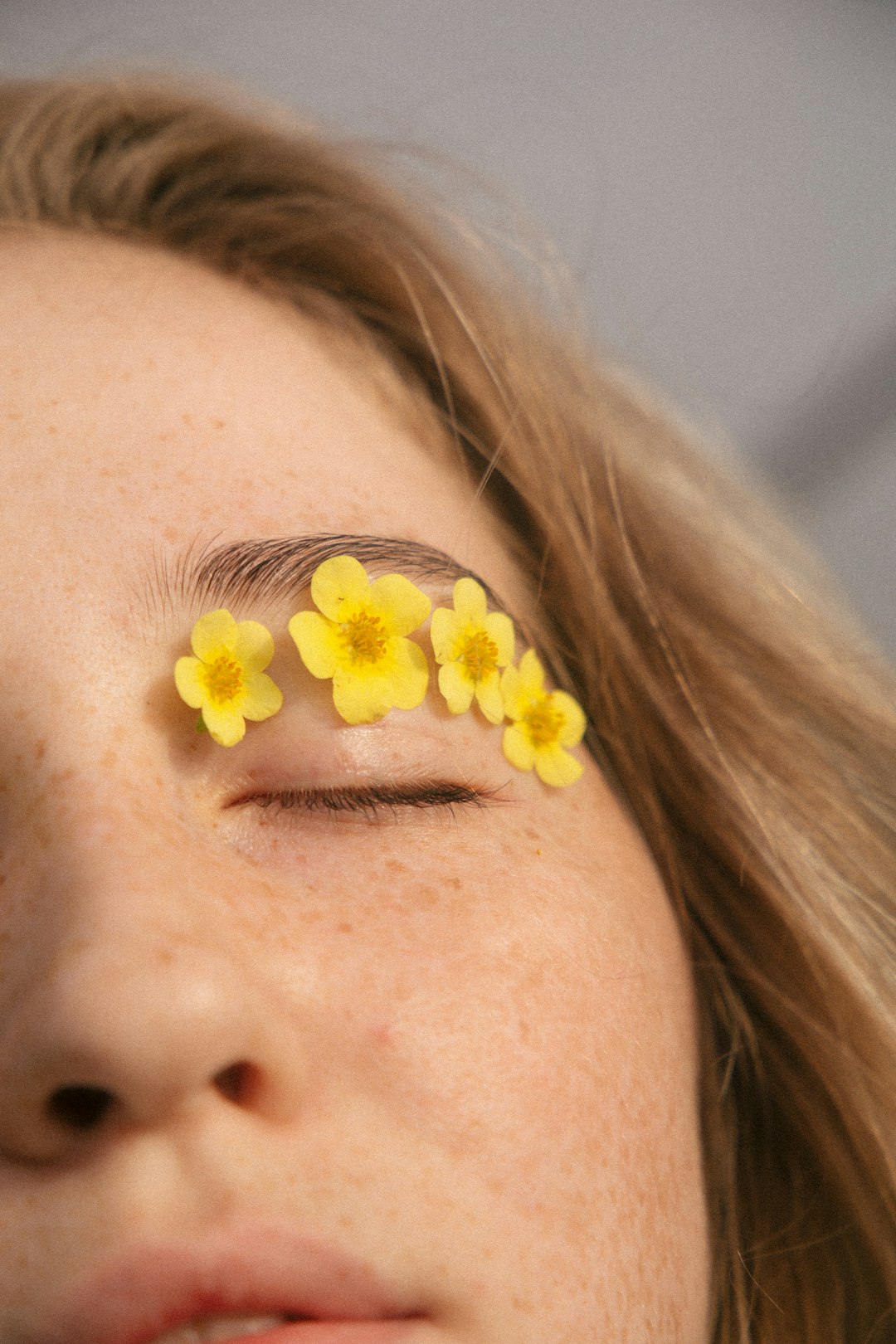 woman with yellow flower on her ear