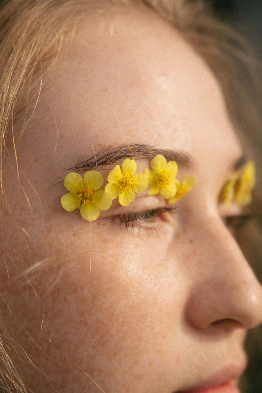 yellow flower on persons ear
