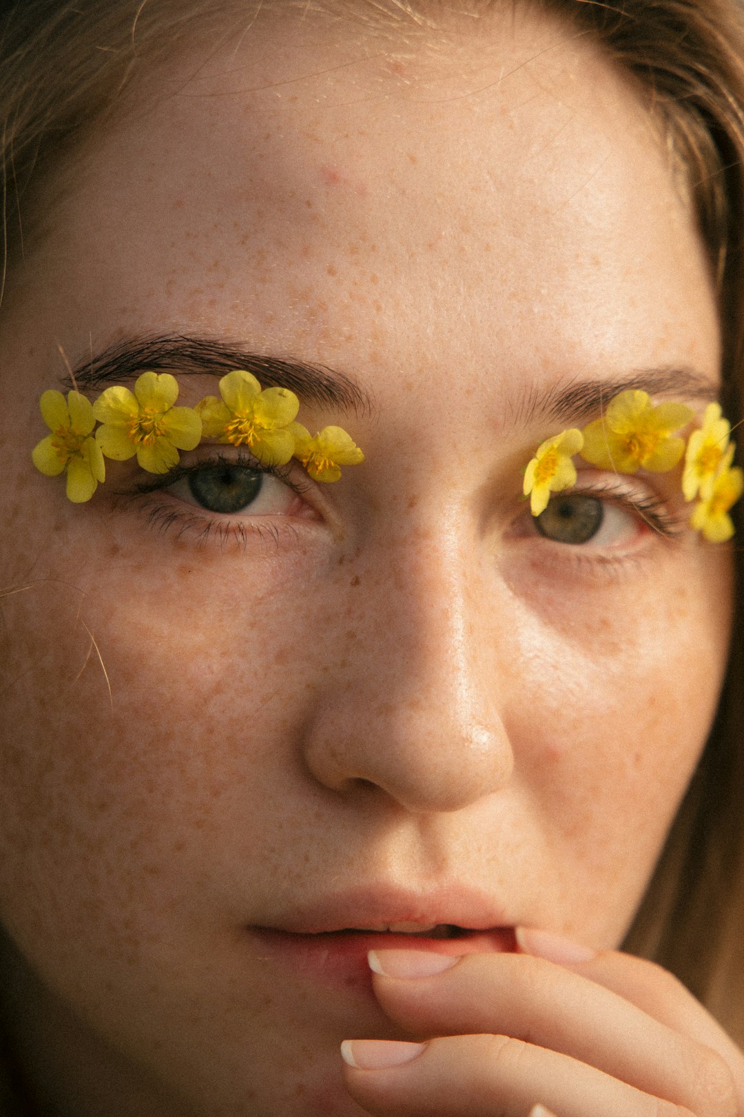 woman with yellow flower on her ear