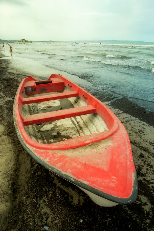 red and white boat on seashore during daytime in Durrës Albania
