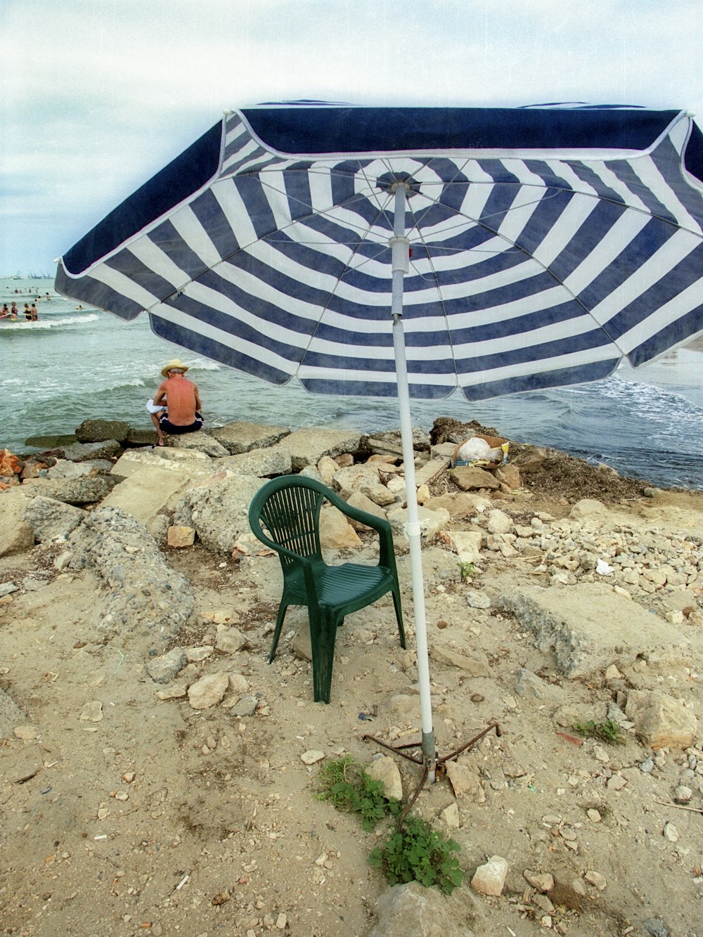 green and white patio umbrella on beach shore during daytime