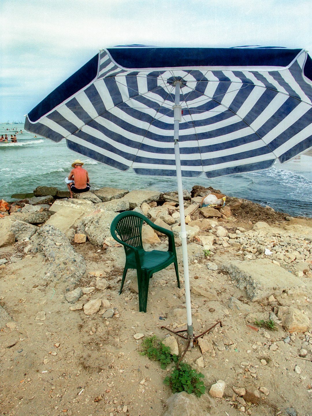 green and white patio umbrella on beach shore during daytime