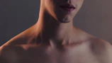 Close-up of a client's jawline before and after contouring treatment under warm, neutral lighting.