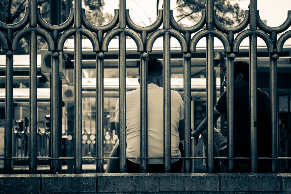 person in white shirt standing near window