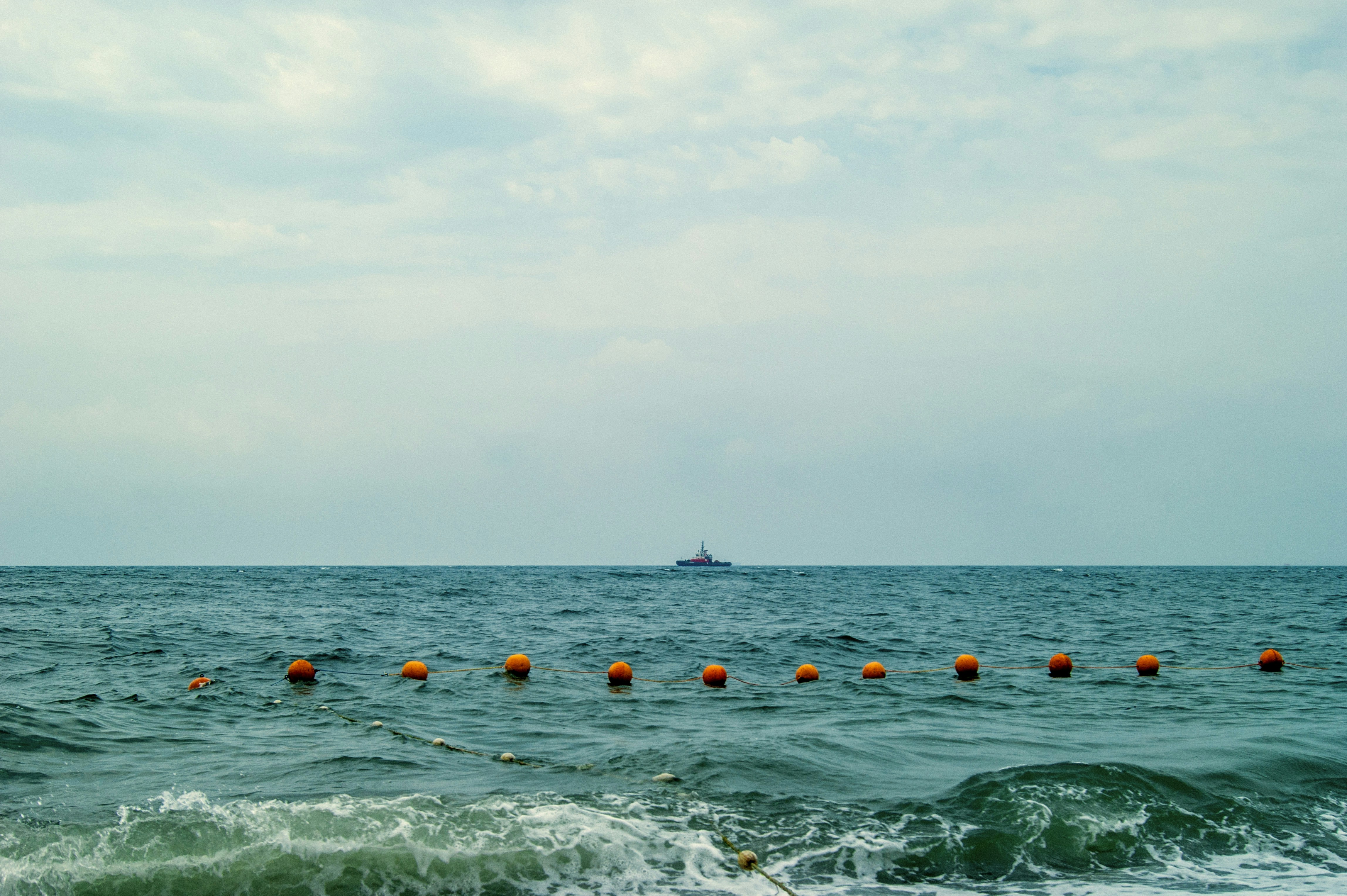 people swimming in the sea during daytime