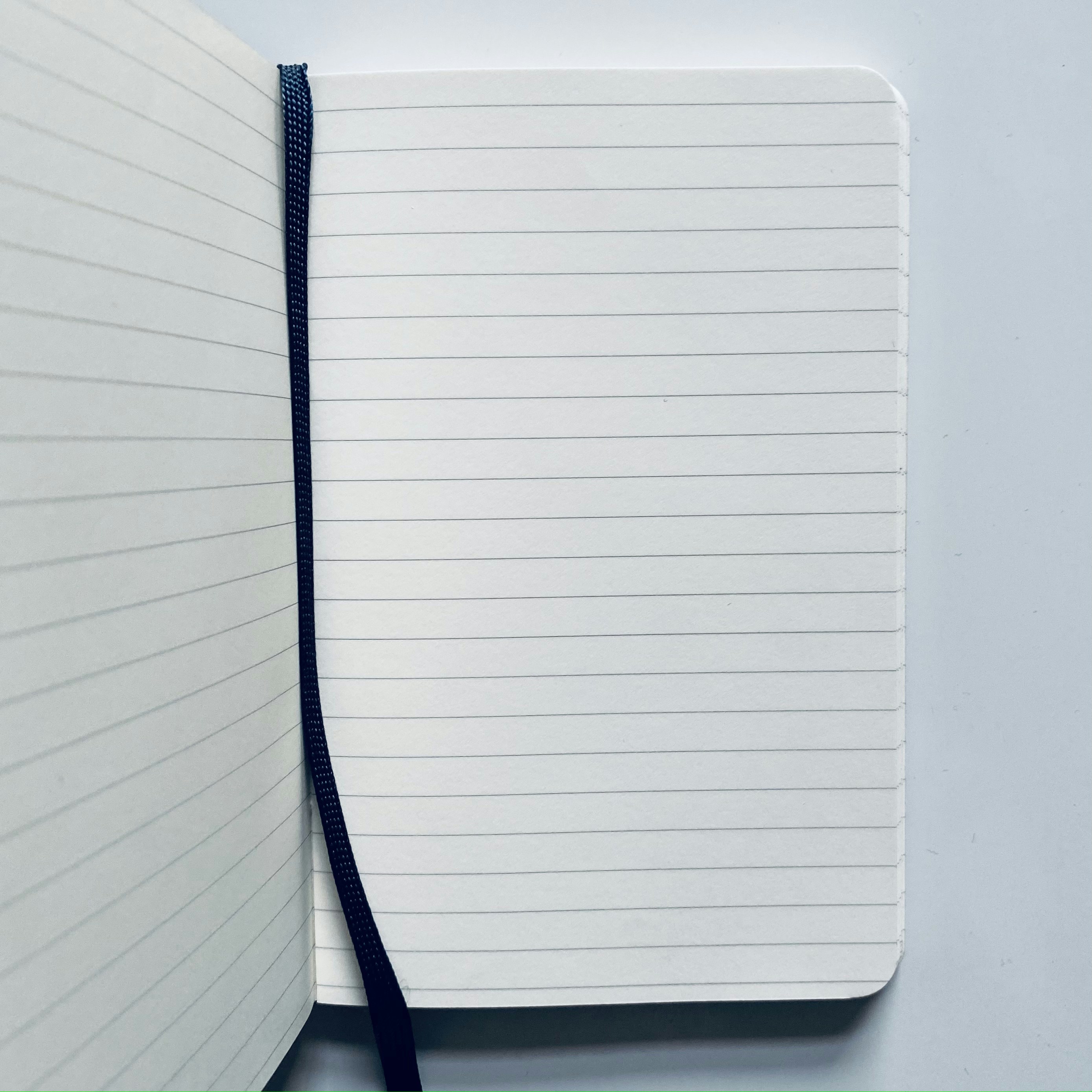 Small lined copy notebook on white background