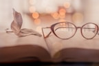 brown framed eyeglasses on book page