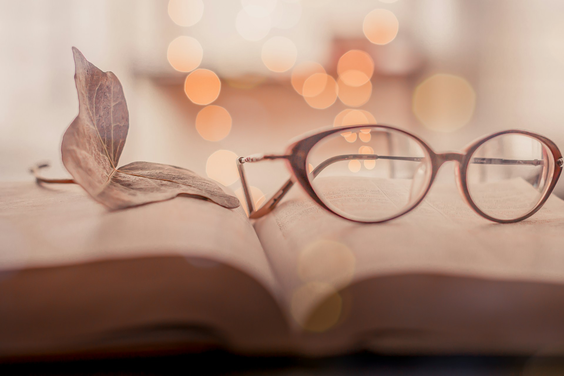 brown framed eyeglasses on book page