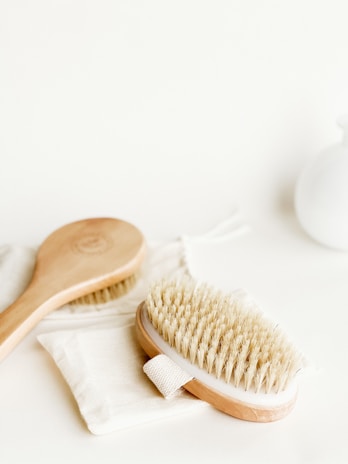 A set of sturdy brushes with wooden handles displayed against a clean white background.