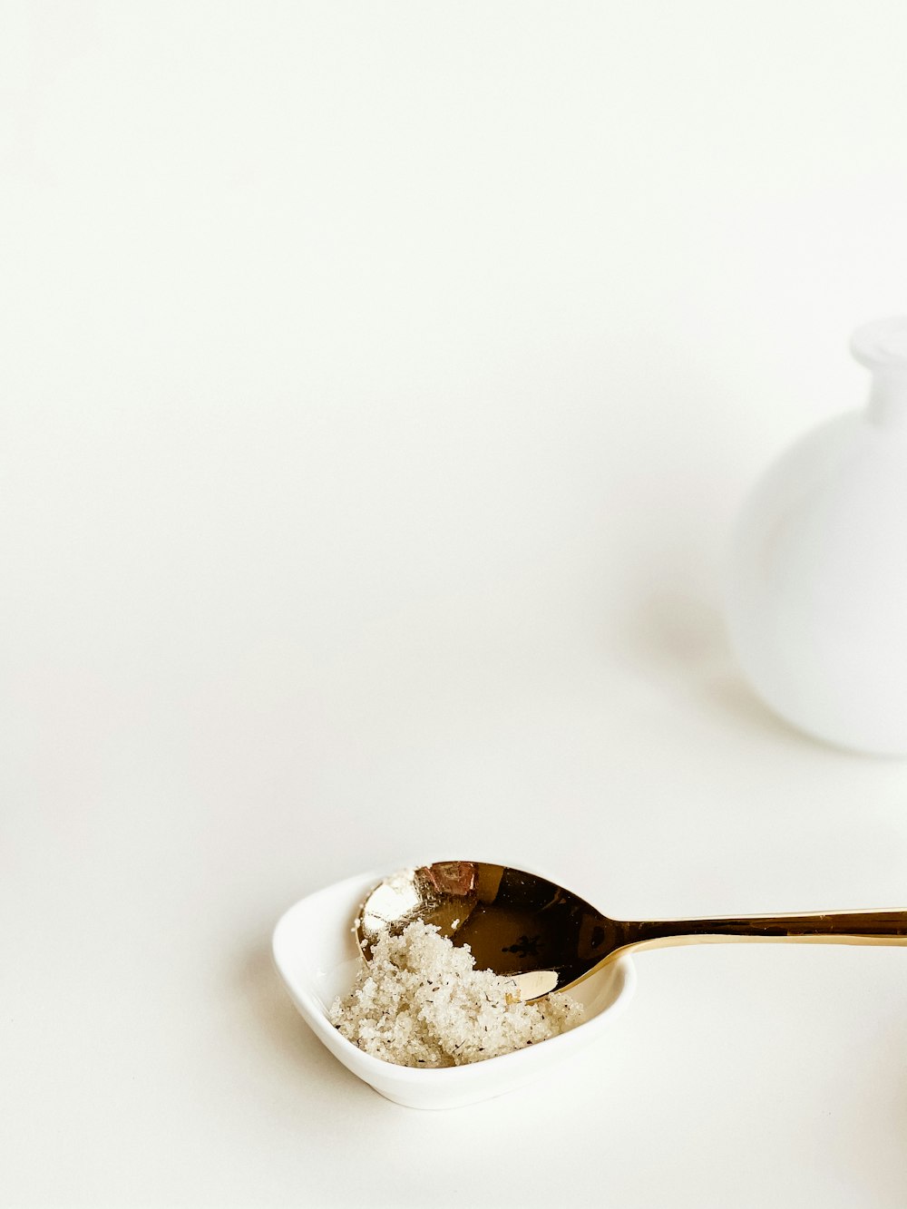 white ceramic teapot on white ceramic bowl