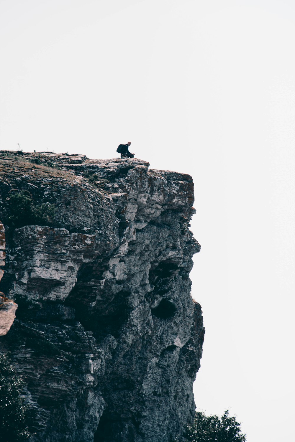 person standing on rock formation during daytime