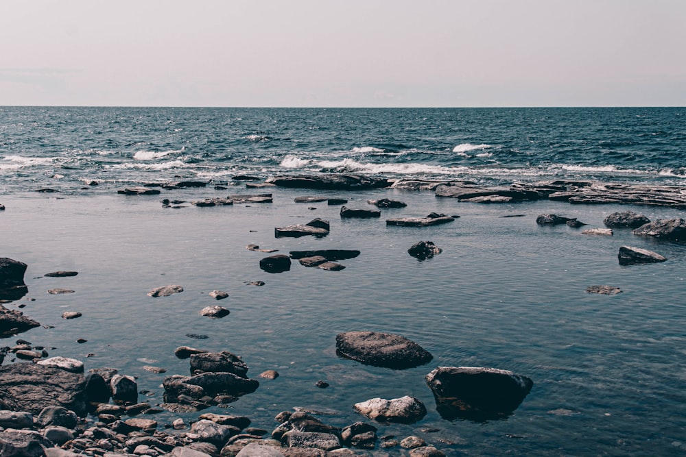 rocks on body of water during daytime