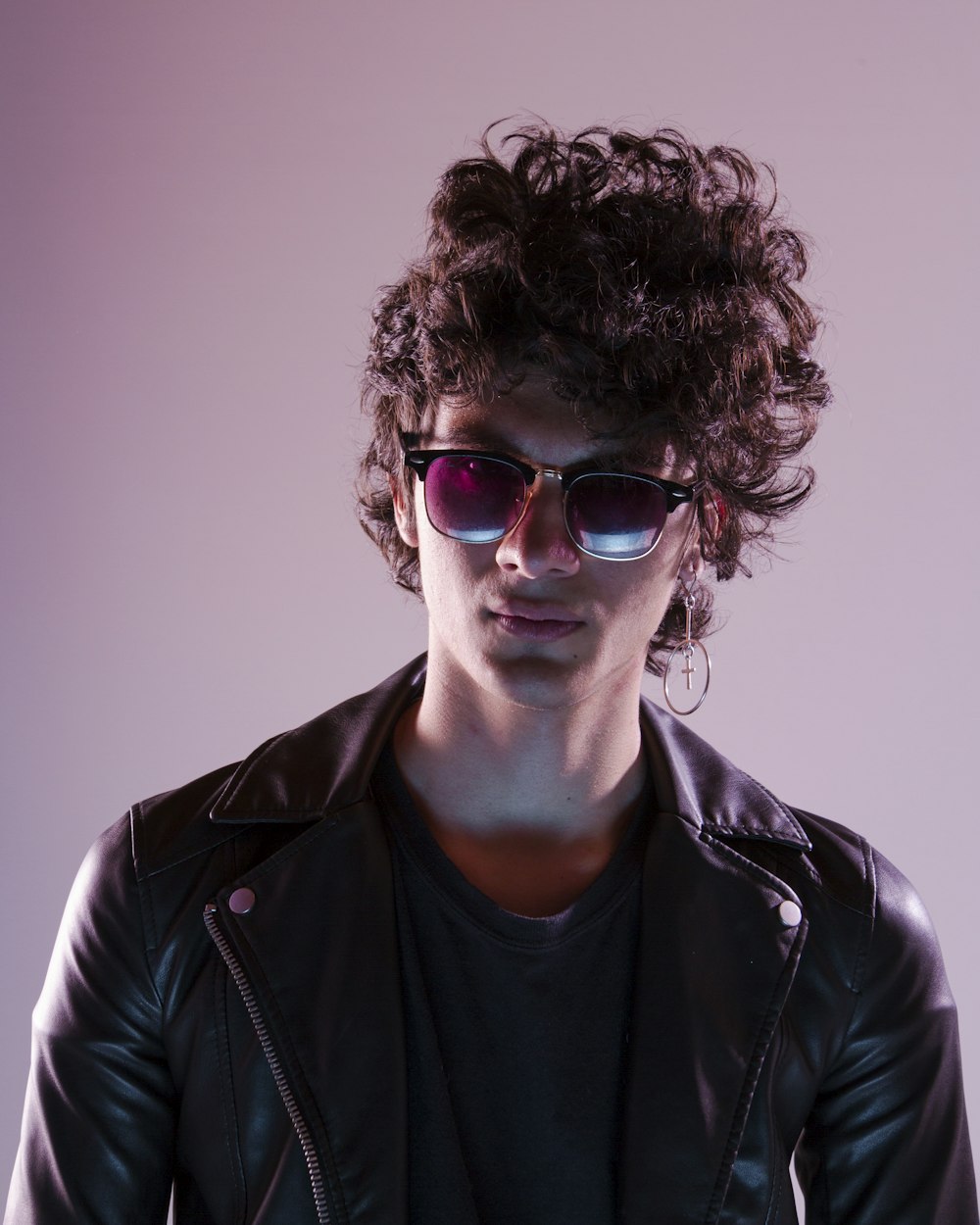 man in black leather jacket wearing sunglasses