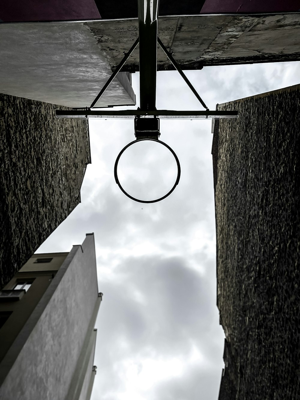 black basketball hoop under cloudy sky during daytime