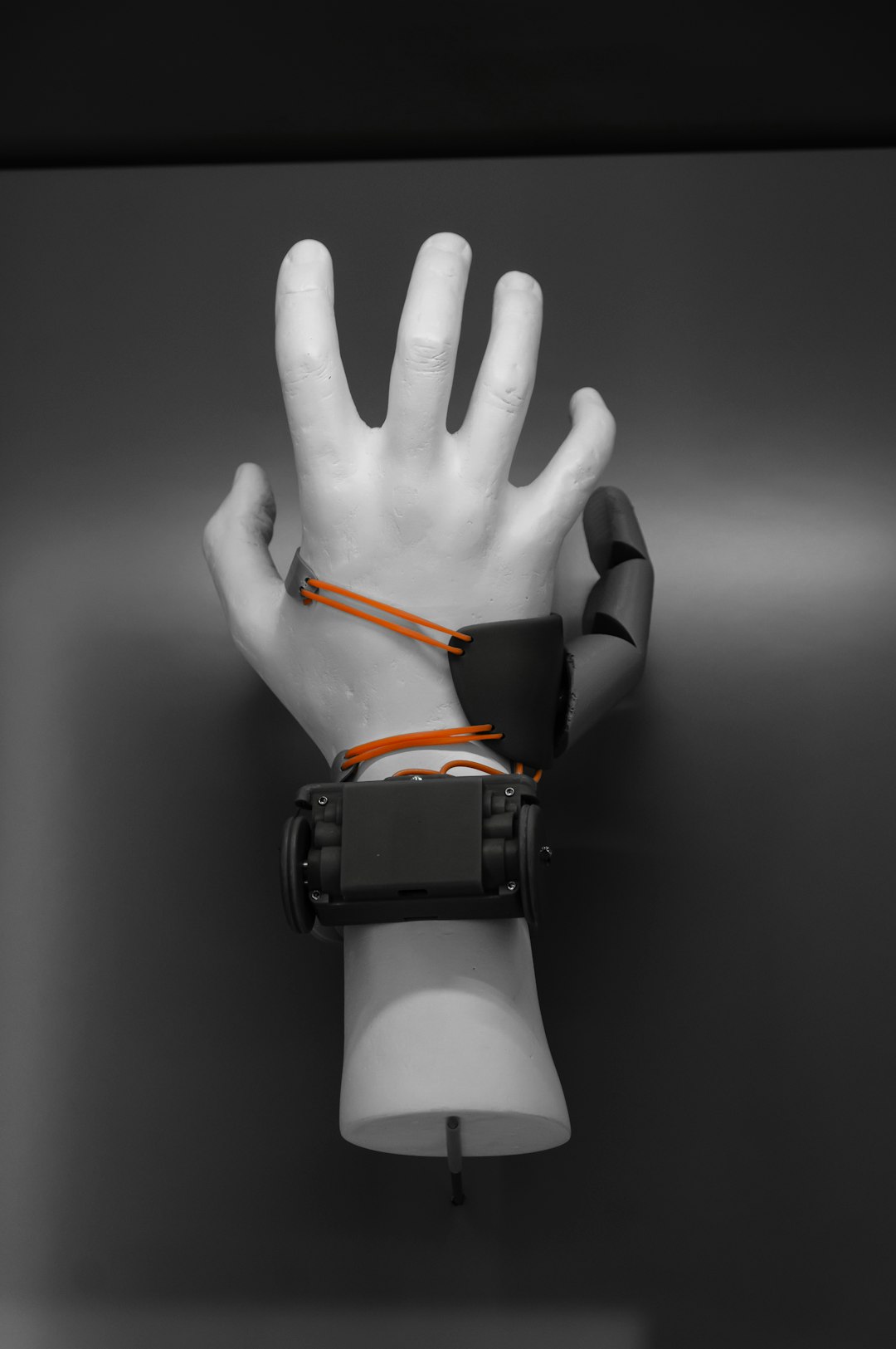 person wearing black and orange watch