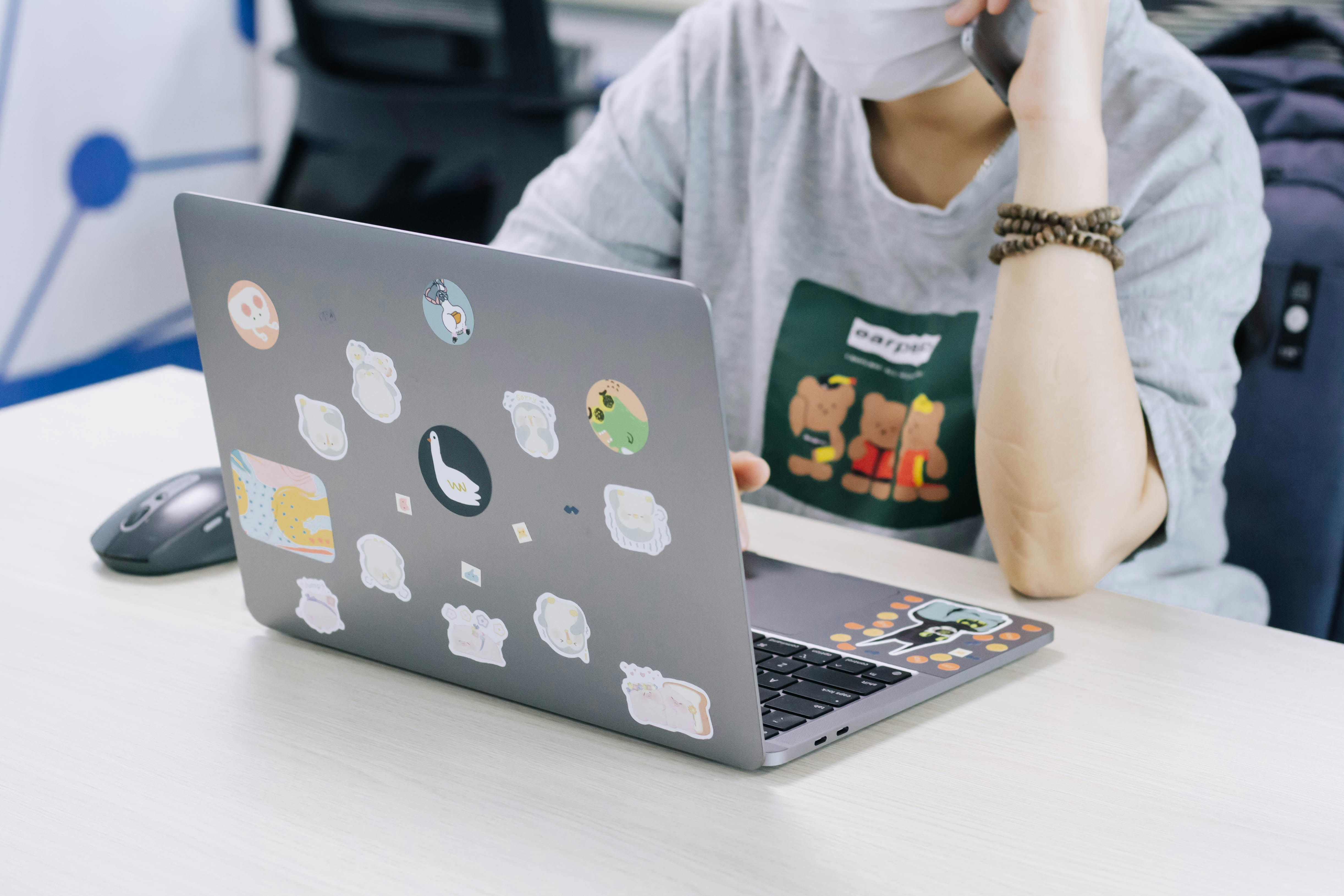 woman in white hijab using macbook pro