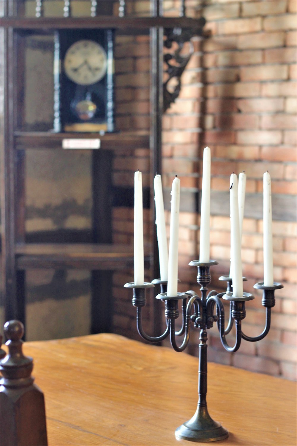 white candles on brass candle holder