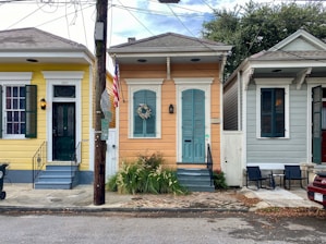 A neat row of rental houses with americanave signage in front.