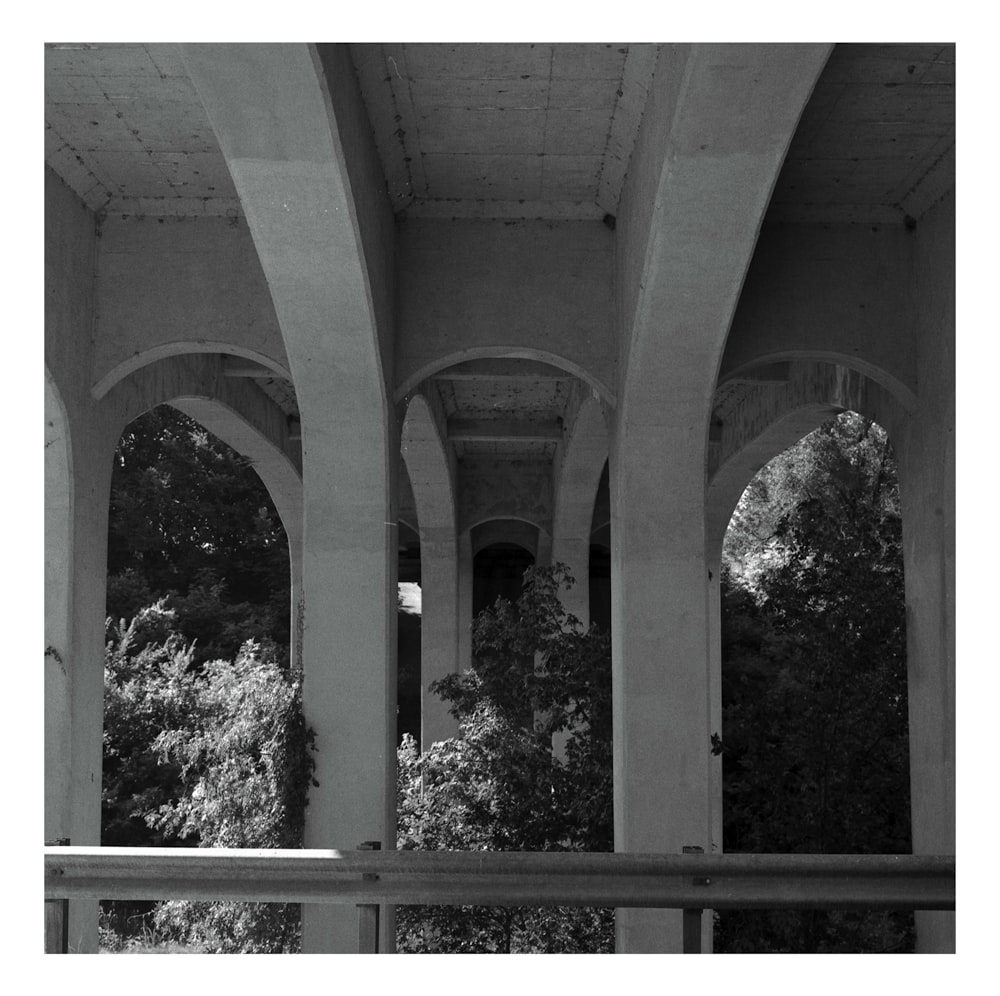 grayscale photo of concrete bridge